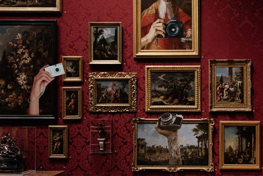 Gallery wall with hands holding cameras